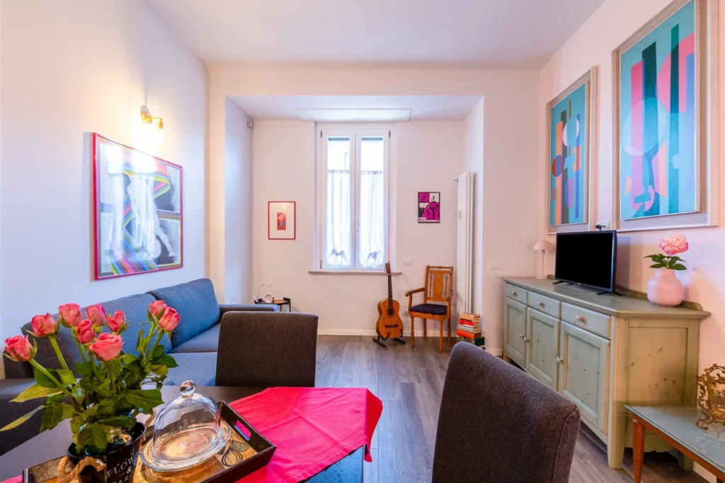 Living and dining area with colorful furniture inside the Colorful Eclectic apartment by Townhomes Milano.