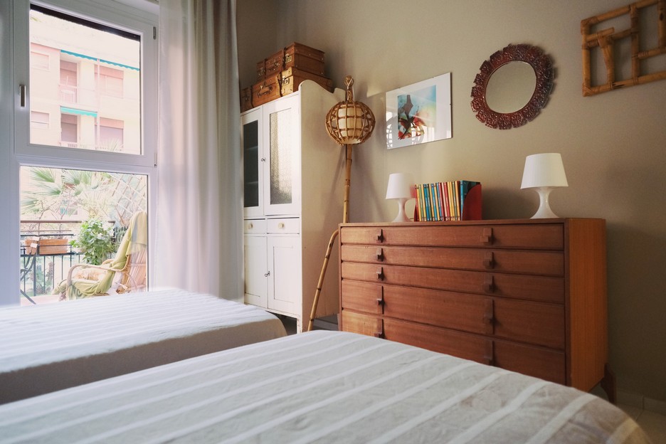 Bedroom with dresser and mirror creating a warm and organized space at Casa Rosy apartments in Diano Marina.