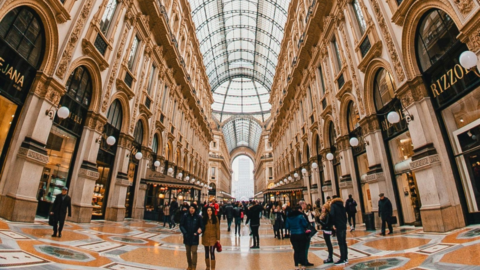 The ornate central octagon of Galleria Vittorio Emanuele II, illustrating the intersection of luxury retail and historic Milanese architecture.