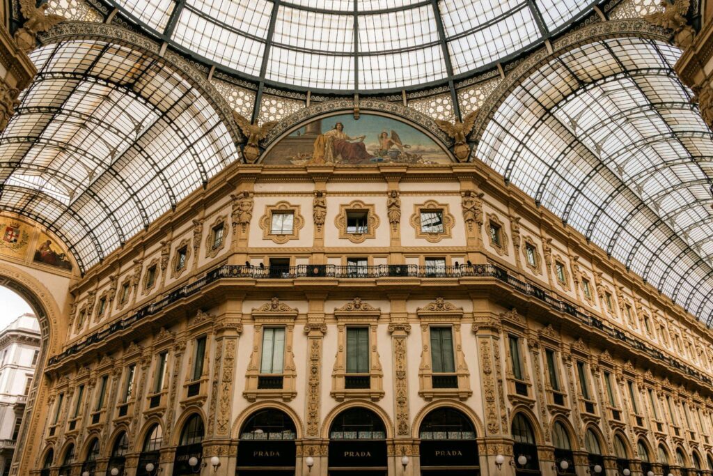The iconic glass-vaulted ceiling of Galleria Vittorio Emanuele II, Milan’s premier destination for luxury shopping and architecture.