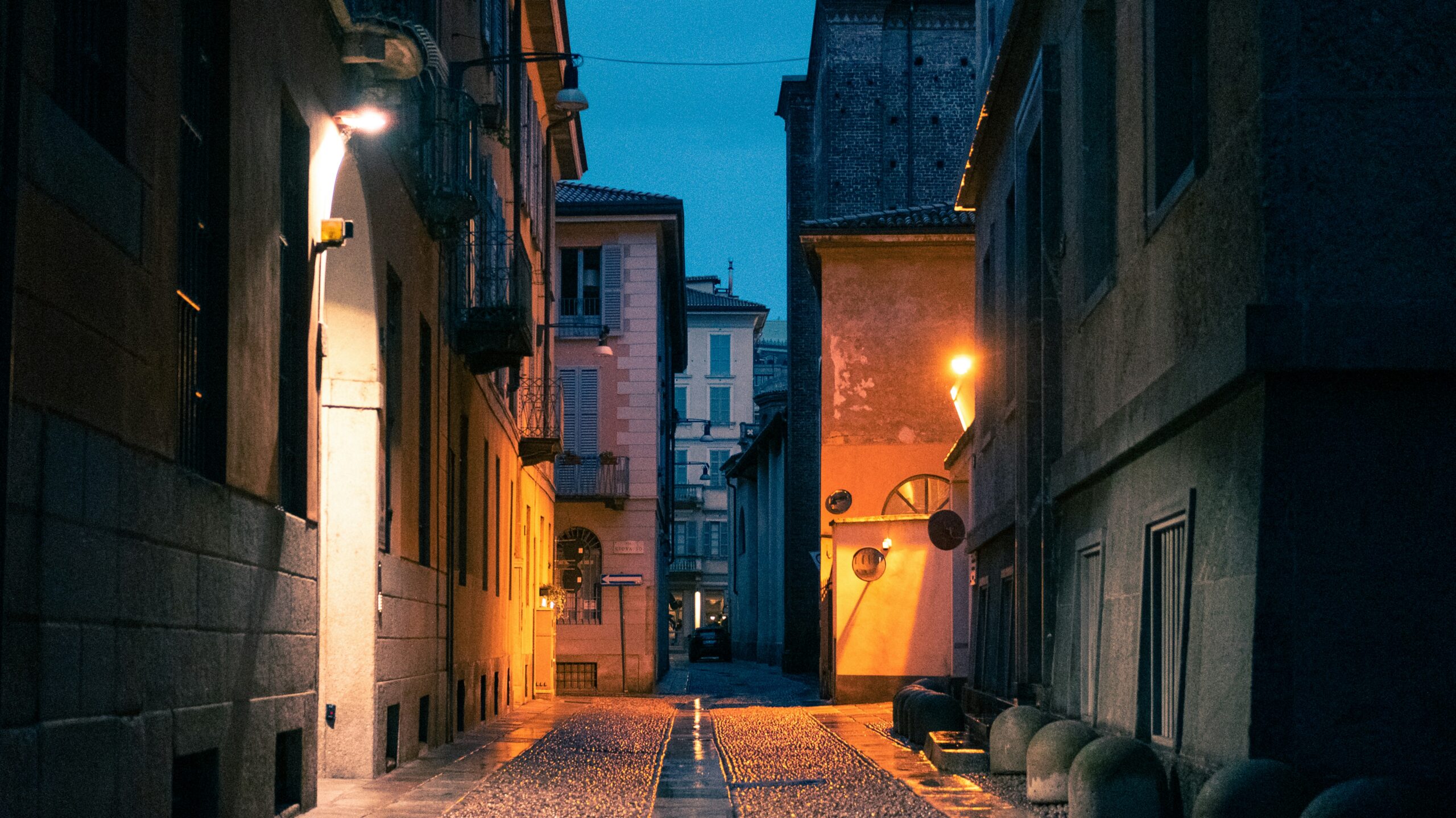 Historic Brera neighborhood street at dusk with traditional Italian buildings and warm lighting